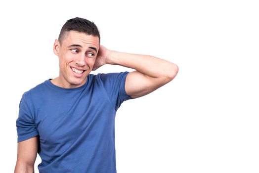 Studio photo with white background of a shy man with his hand on the back of his neck dissimulating