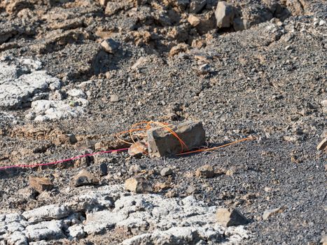 Explosive works in quarry , drilled rocks stuffed with explosives and colorful ignition lines. Holes for explosive filing in basalt mine