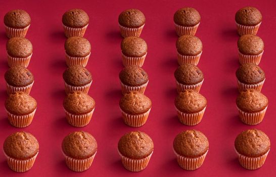 vanilla mini muffins on a red background. Place for your text. Cupcake pattern. Muffin texture. Background. High quality photo