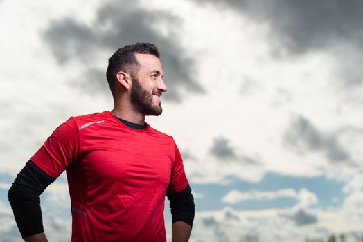 Sporty man looking happy and smiling to the side. High quality photo