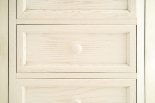 Vintage beautiful restored wooden chest of drawers, painted white, with round door handles. Wardrobe in Provence style.