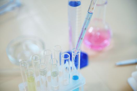 Selective focus on lab glassware with chemicals and reagents on the table in scientific research laboratory. Still life. Science. Chemistry. Medicine and pharmacology