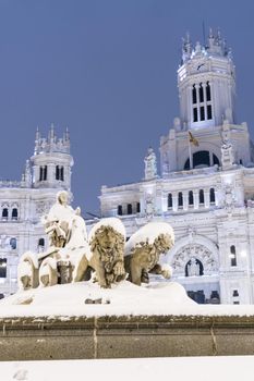 Plaza de la Cibeles in Madrid on a cold winter night after a heavy snowfall.