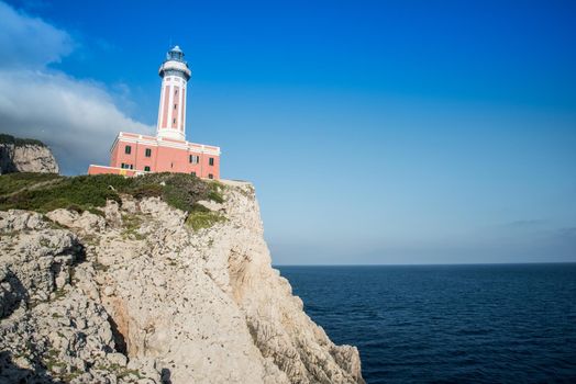 Seascape with a lighthouse on the coast and the sea. Capri island.