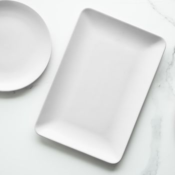 White empty plate on marble, flatlay - stylish tableware, romantic table decor and food menu concept. Serve the perfect dish