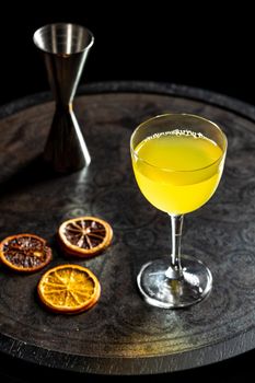 Refreshing citrus and alcoholic cocktail on dark background