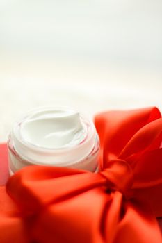 Beauty, cosmetics and skincare styled concept - Luxury face cream jar and red gift box