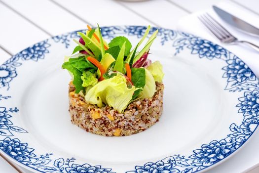 Quinoa salad with avocado, carrot, chickpeas and fresh greens