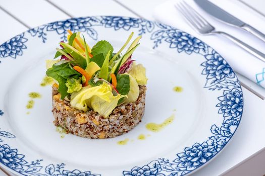 Quinoa salad with avocado, carrot, chickpeas and fresh greens