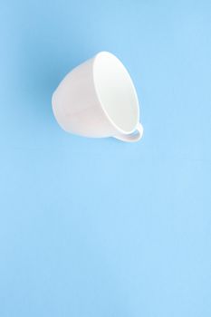 Kitchen, dishware and drinks concept - Empty cup and saucer on blue background, flatlay