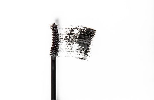 Beauty texture, cosmetic product and art of make-up concept - Black mascara brush stroke close-up isolated on white background