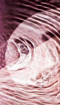 Pink flowing water texture as an abstract background - colourful liquids and creative designs concept. Pink flow