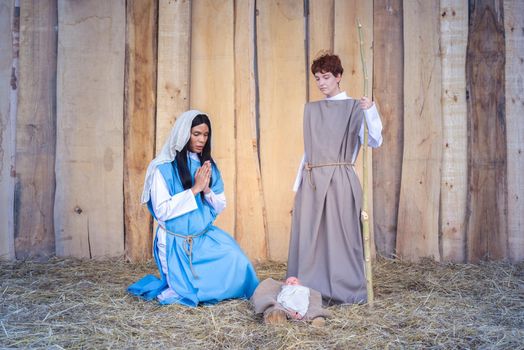 Christmas crib with two transgender people representing a scene of Mary and Joseph