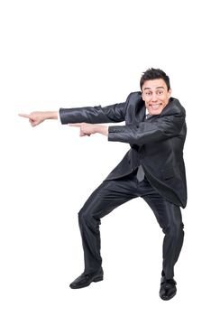 Full body of delighted male in formal suit pointing aside and looking at camera with smile while promoting ad isolated on white background