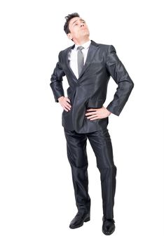 Full body of haughty male in formal outfit looking up with hands on waist isolated on white background in studio