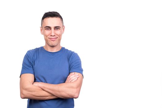 Studio portrait with white background of a man with arms crossed with proud expression