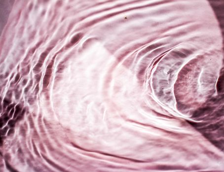 Pink flowing water texture as an abstract background - colourful liquids and creative designs concept. Pink flow