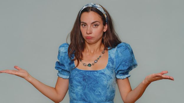 Why, what. Pretty young woman raising hands in indignant expression, asking reason of failure, demonstrating disbelief irritation by troubles. Adult stylish girl isolated on gray studio background