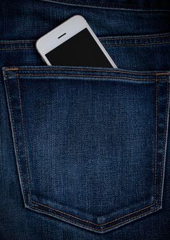 mobile phone seen from the back pocket of jeans, blue denim. Concept phone always with you. High quality photo