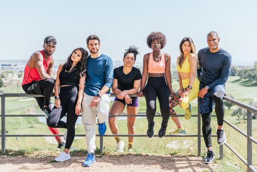 Group portrait of runners looking seriously at camera. Horizontal framing.