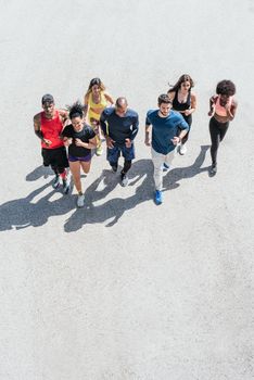 Group of runners running. Top view. Horizontal framing.