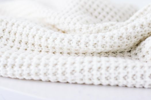 Knitwear, fabric textures and handmade items concept - Warm knitted clothes, soft and white