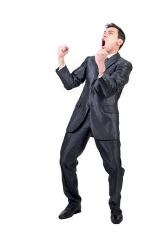 Full body of gleeful male in formal suit screaming with clenched fists while celebrating victory isolated on white background in studio