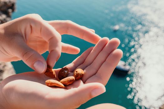 Unrecognizable caucasian woman eating young milky almond nuts. Healthy vegan food