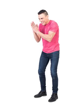 Full body of young evil male with dark hair in casual clothes smiling and rubbing hands against white background