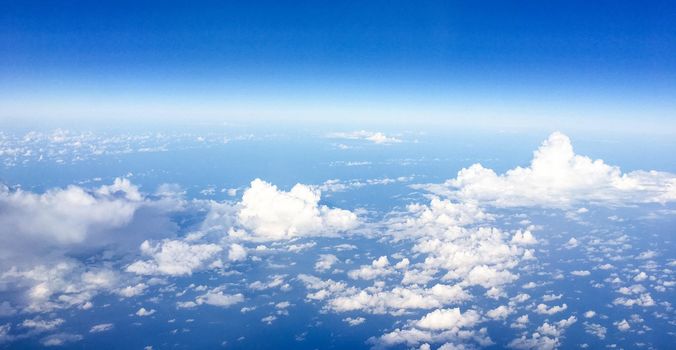 Travel, cloudscape and natural environment concept - View from the airplane window, sky and ocean blue