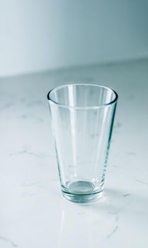 Glassware, washing and purity concept - Clean empty glass on marble table