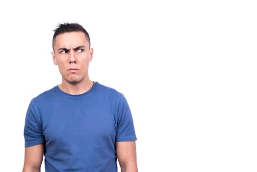 Studio photo with white background of a man looking to one side with a distrustful expression