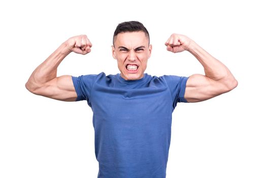 Studio portrait of a man with expression of strength with raised arms showing his biceps