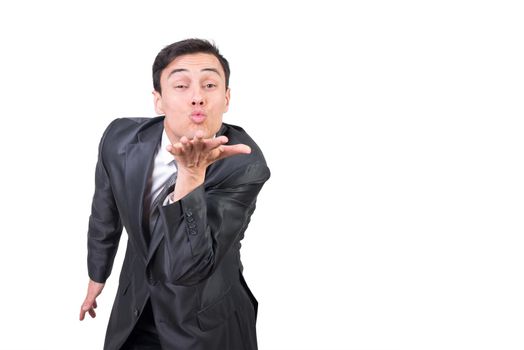 Mid shot of male in formal wear looking at camera while sending air kiss isolated on white background in studio