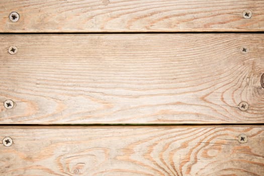 Wooden boards background. Light wood texture with bolts