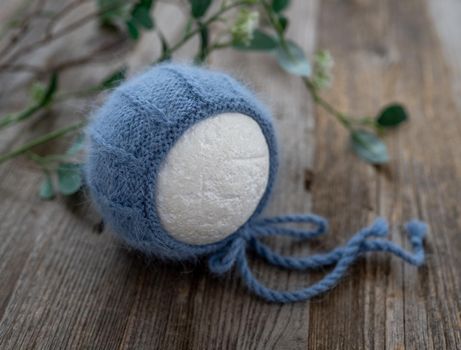 tender knitted for newborn on wooden background