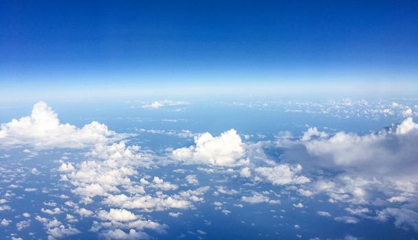 Travel, cloudscape and natural environment concept - View from the airplane window, sky and ocean blue