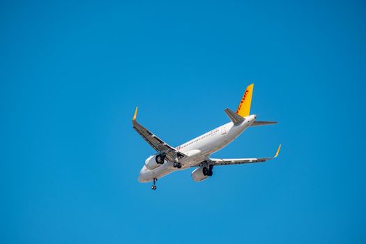 Commercial airplane flying high in clear blue sky