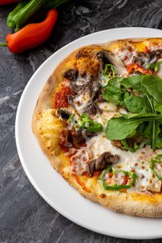 Delicious hot homemade pizza on the stone table background