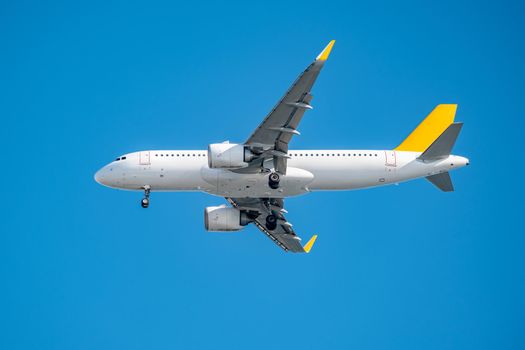 Commercial airplane flying high in clear blue sky