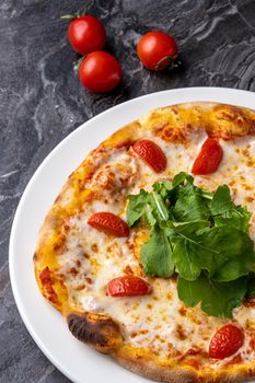 Delicious hot homemade pizza on the stone table background