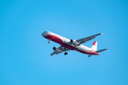 Commercial airplane flying high in clear blue sky