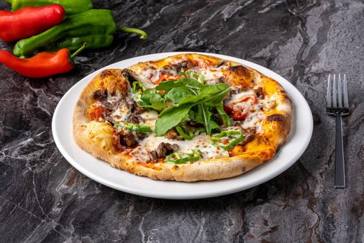 Delicious hot homemade pizza on the stone table background