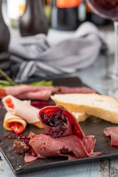 Appetizers table with italian antipasti snacks and wine in glasses