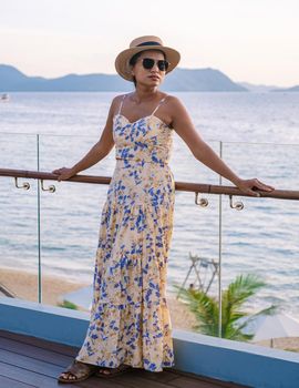 Asian women with a hat by the swimming pool in Pattaya Thailand Ban Amphur beach, women on a luxury vacation