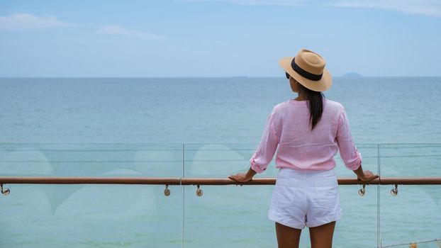 Asian women with a hat by the swimming pool in Pattaya Thailand Ban Amphur beach, women on a luxury vacation