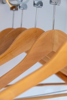 Wooden dress hangers in order in the wardrobe