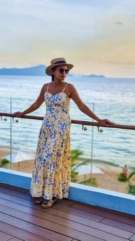 Asian women with a hat by the swimming pool in Pattaya Thailand Ban Amphur beach, women on a luxury vacation