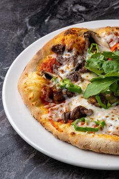 Delicious hot homemade pizza on the stone table background