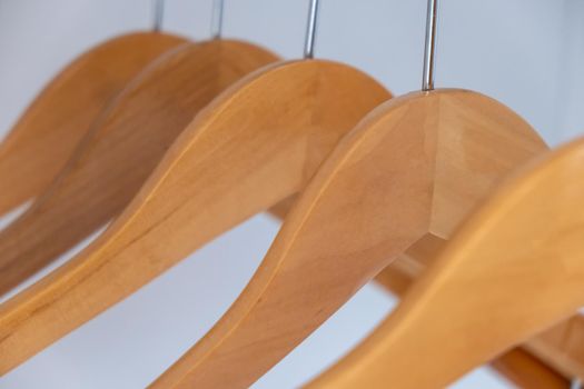 Wooden dress hangers in order in the wardrobe